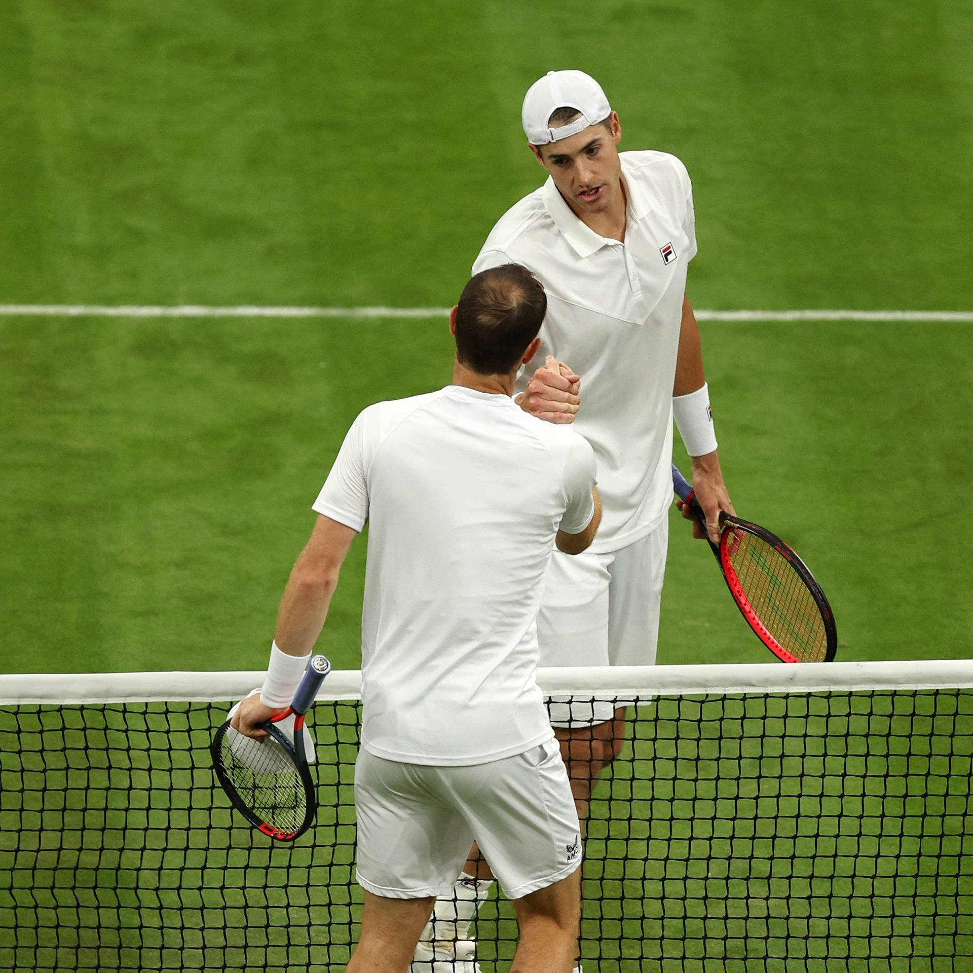 American Tennis Star John Isner Showcasing True Sportsmanship On The Court Background