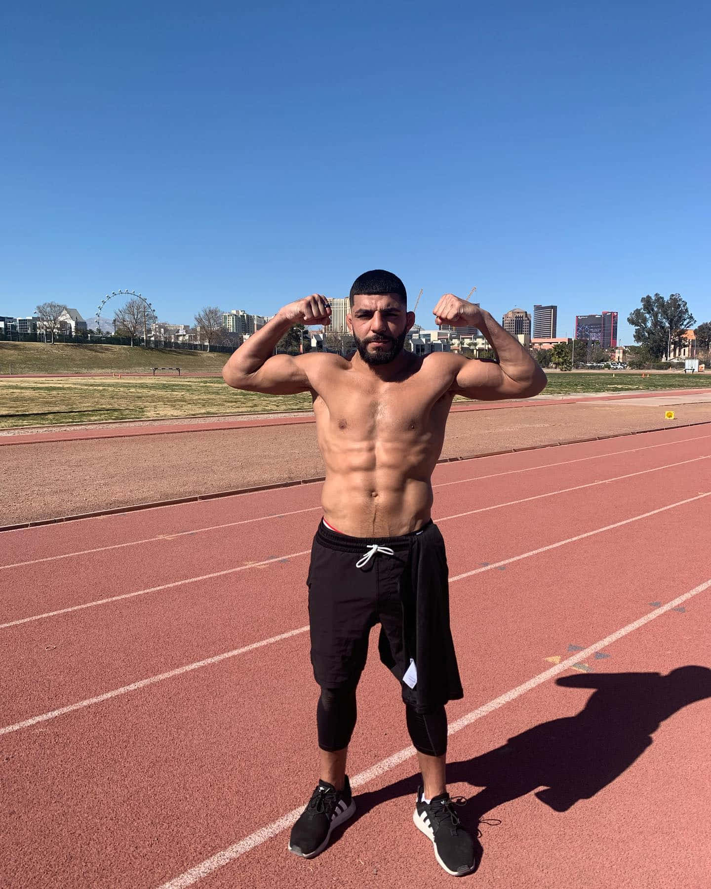 Amir Albazi Posing On Racetrack Background