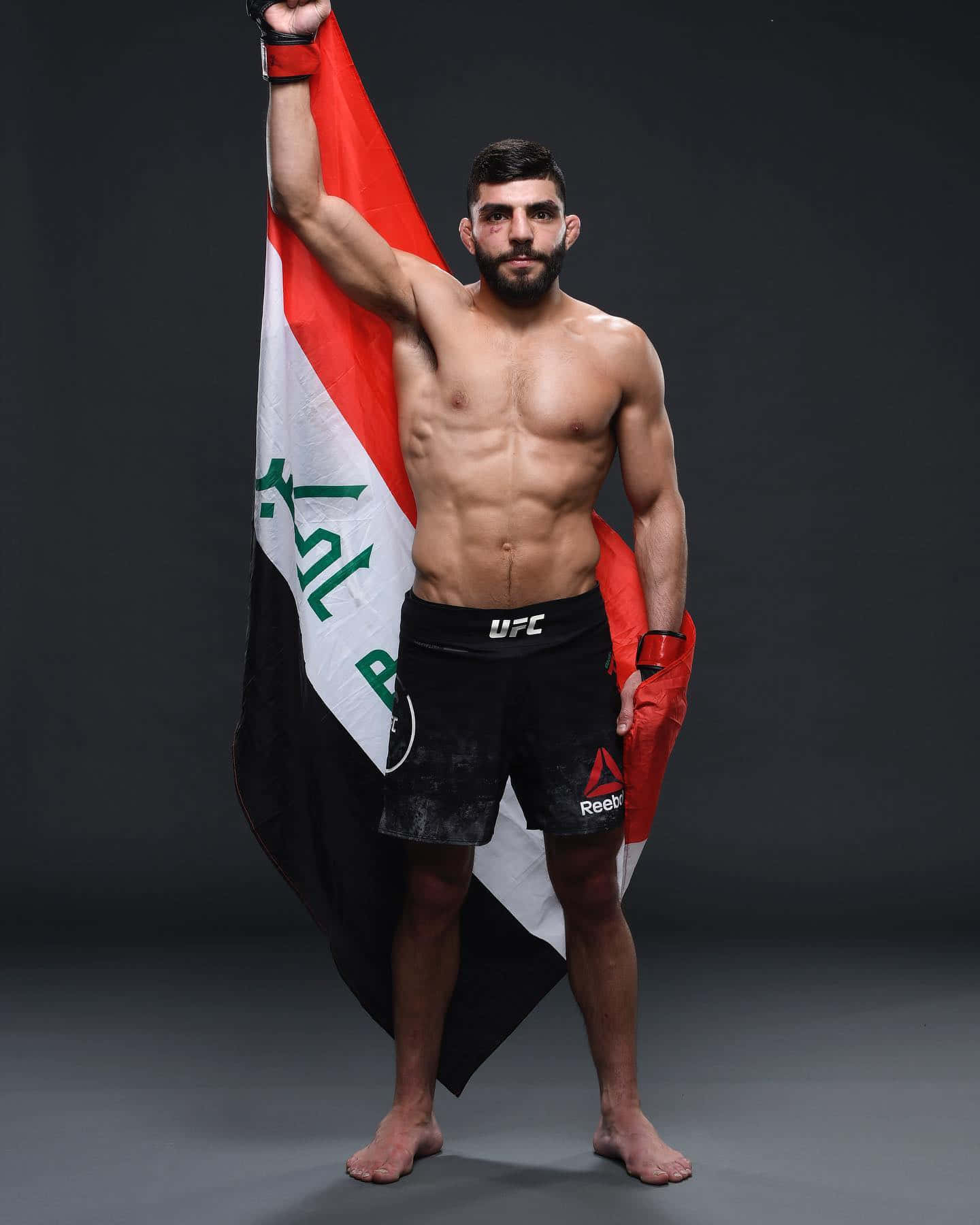 Amir Albazi Proudly Raising The Iraqi Flag Background