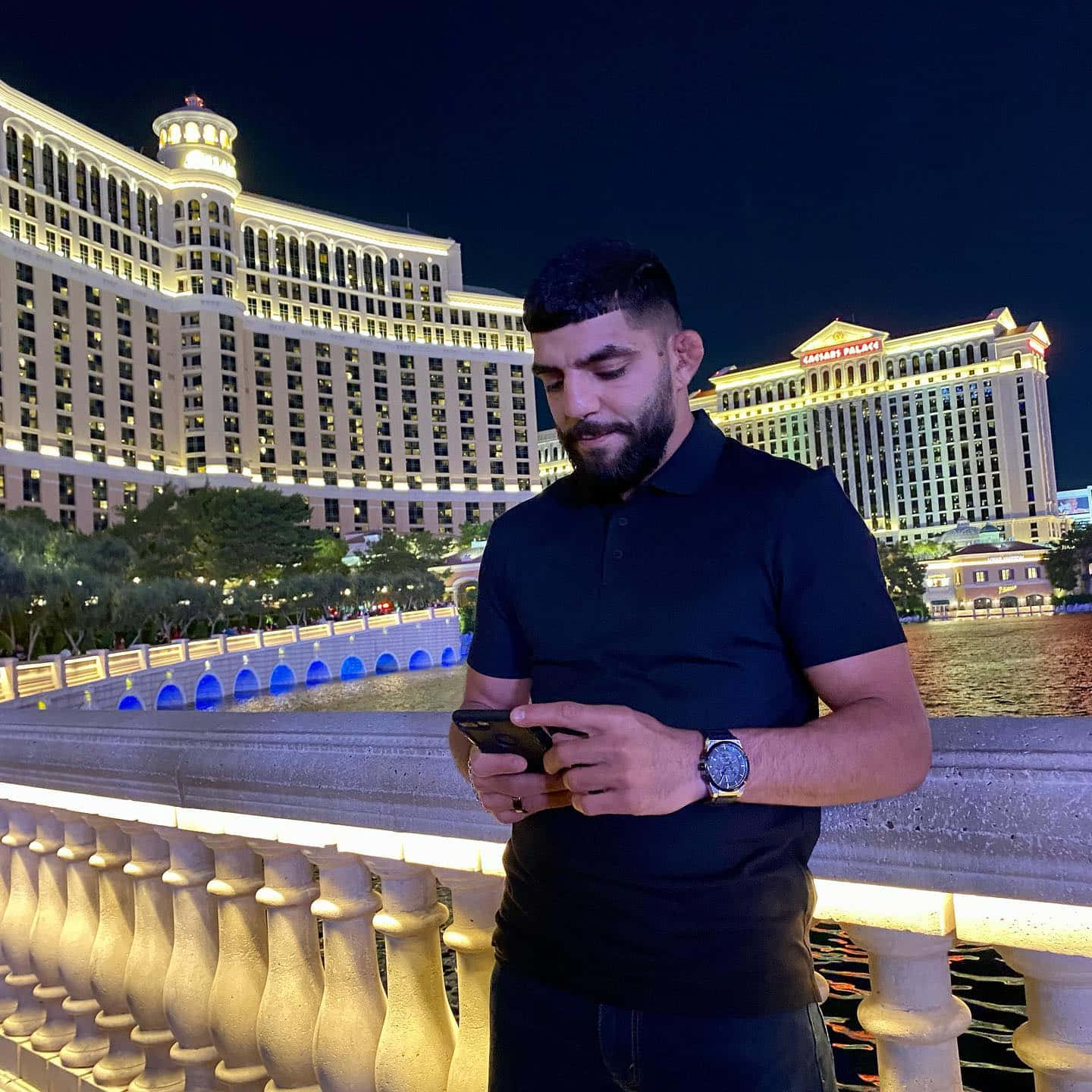Amir Albazi Using Phone In Las Vegas Background