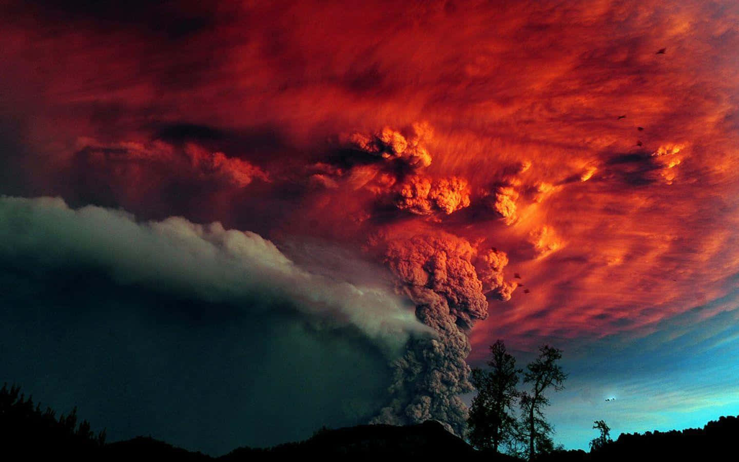 An Active Volcano Spewing Molten Lava Under The Starlit Night Sky Background