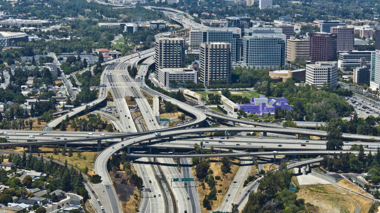 An Aerial View Of A Highway And City