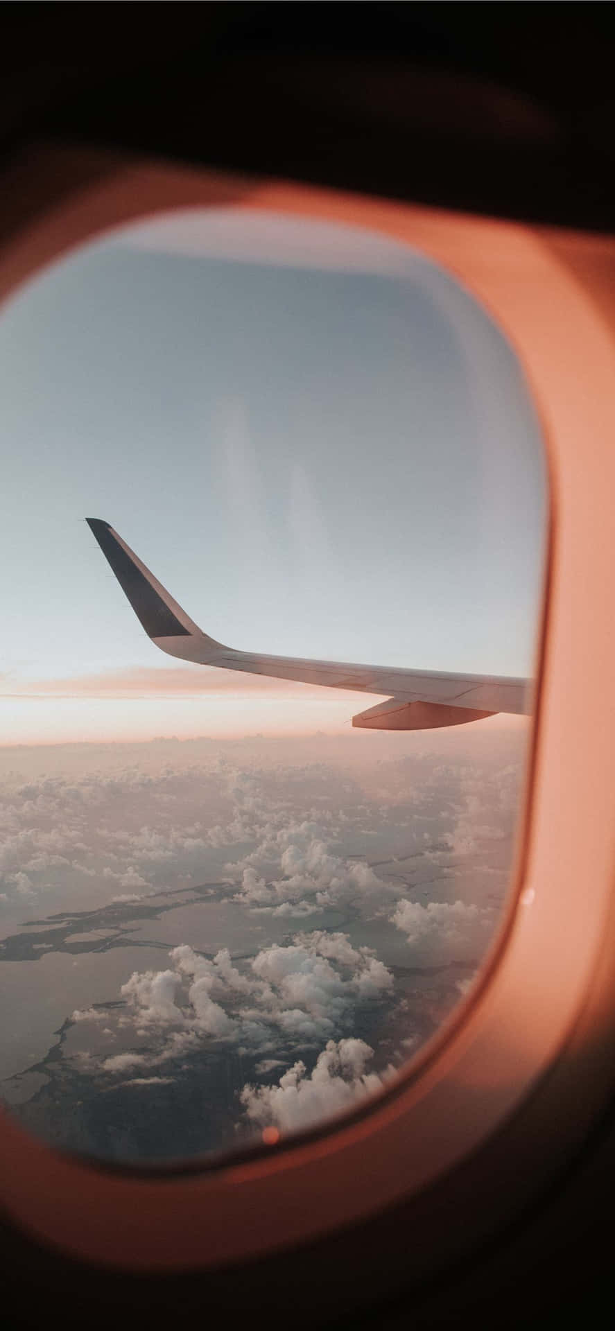 An Airplane Wing Seen Through An Airplane Window Background