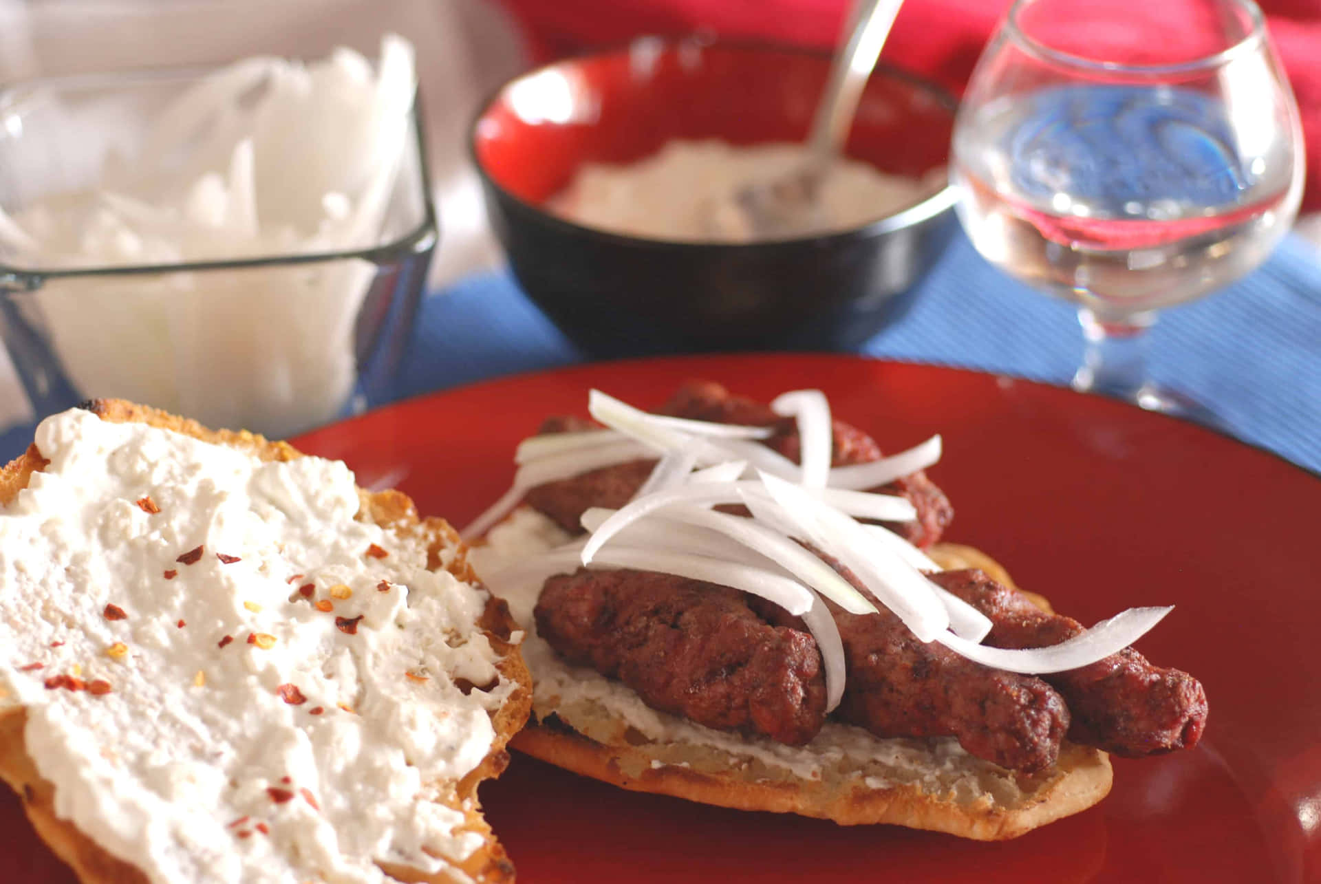 An Appetizing Scene Of Ćevapi Sausages Served In Flatbread Background