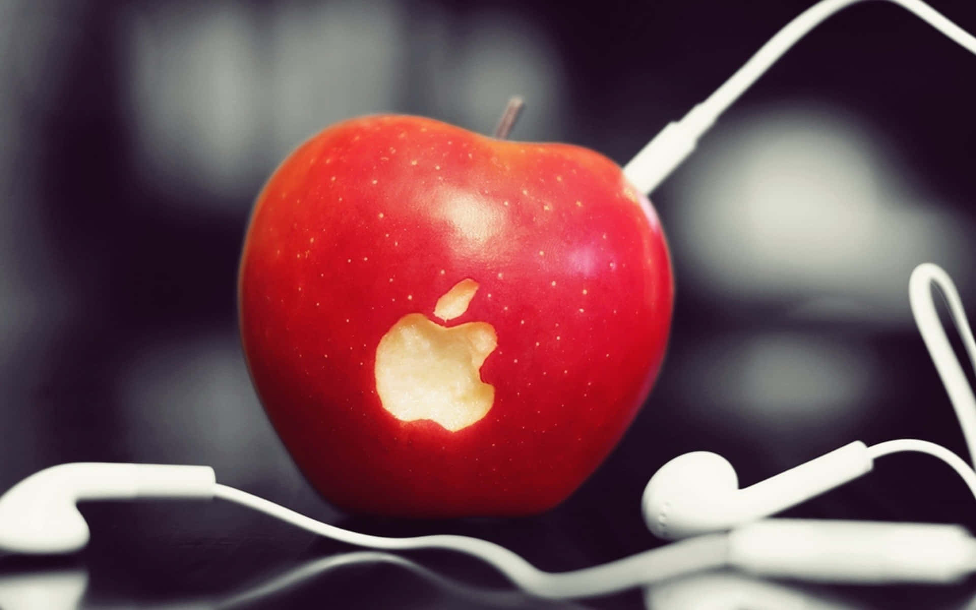 An Apple With Earphones On It Background