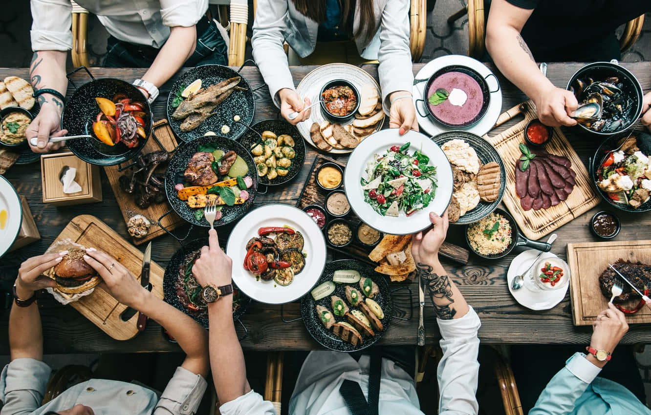 An Array Of Delicious Dishes On A Beautifully Set Dining Table Background