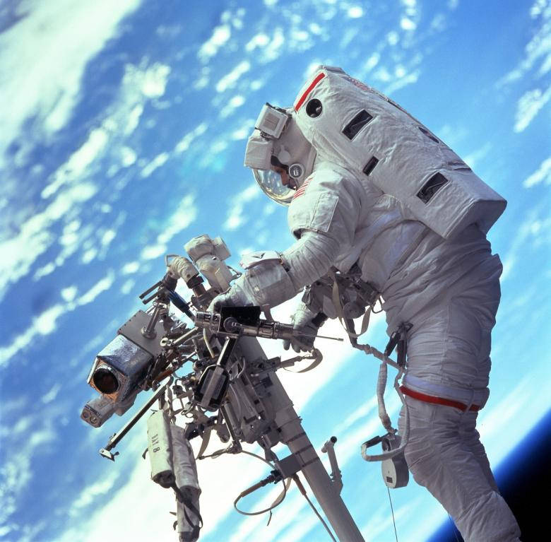 An Astronaut In Space Working Hard Background