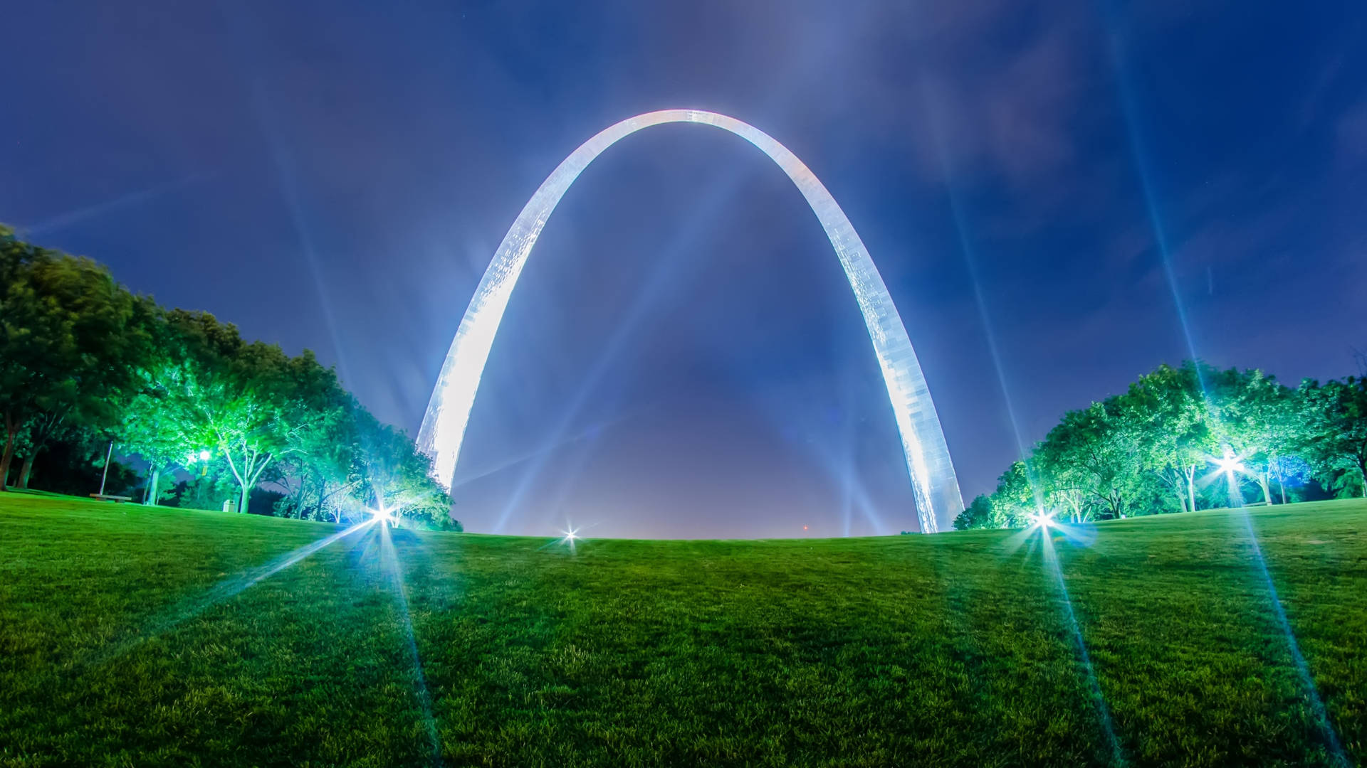 An Attractive Display Of The Splendid St Louis Arch Glowing Under The Lively Night Lights.