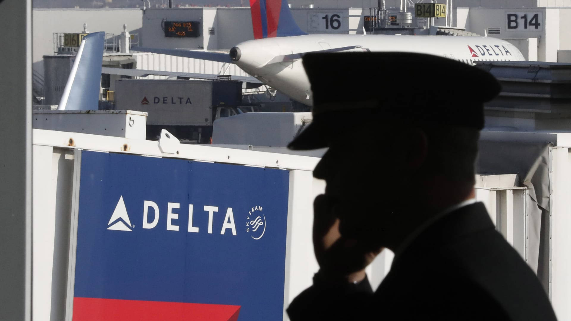 An Aviator From Delta Airlines Looking At The Sky Background