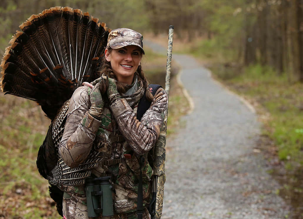 An Avid Hunter Proudly Displays The Results Of A Successful Turkey Hunt. Background