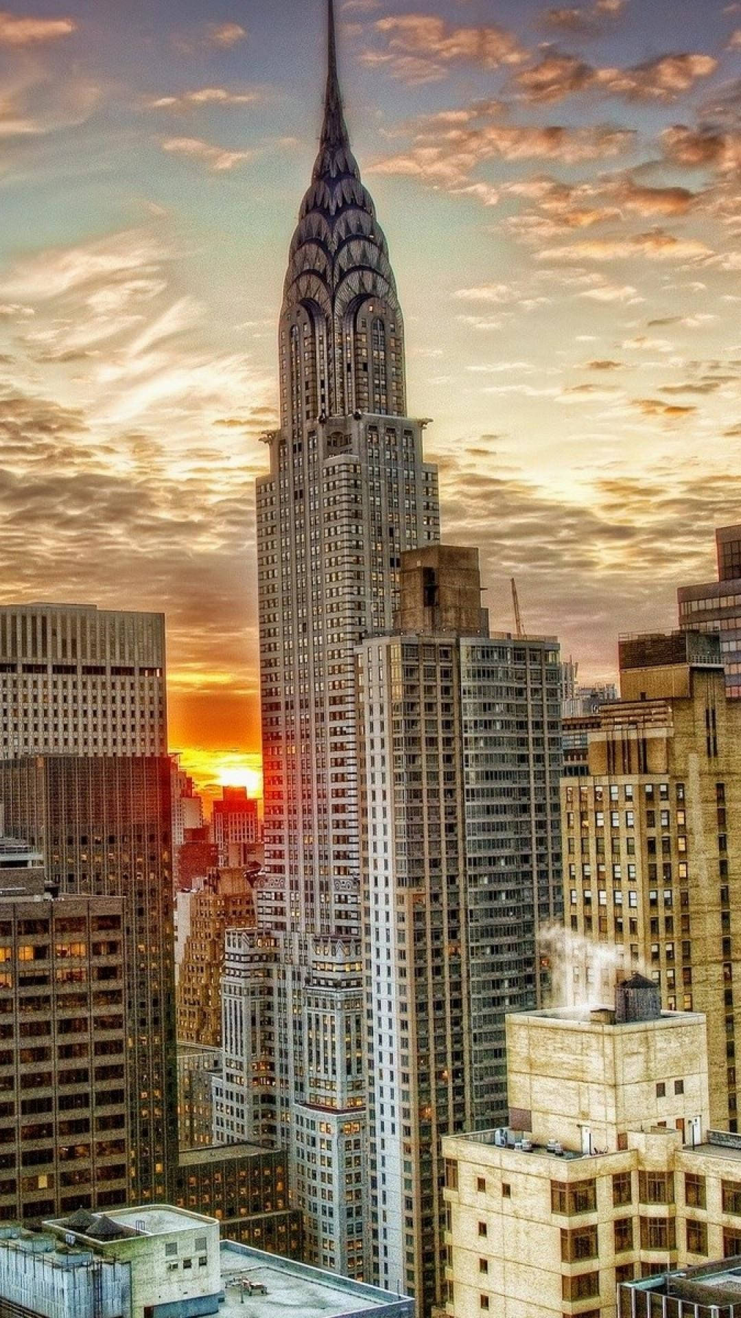 An Awe-inspiring Skyline Of Nyc Lights Glowing In The Nighttime Background