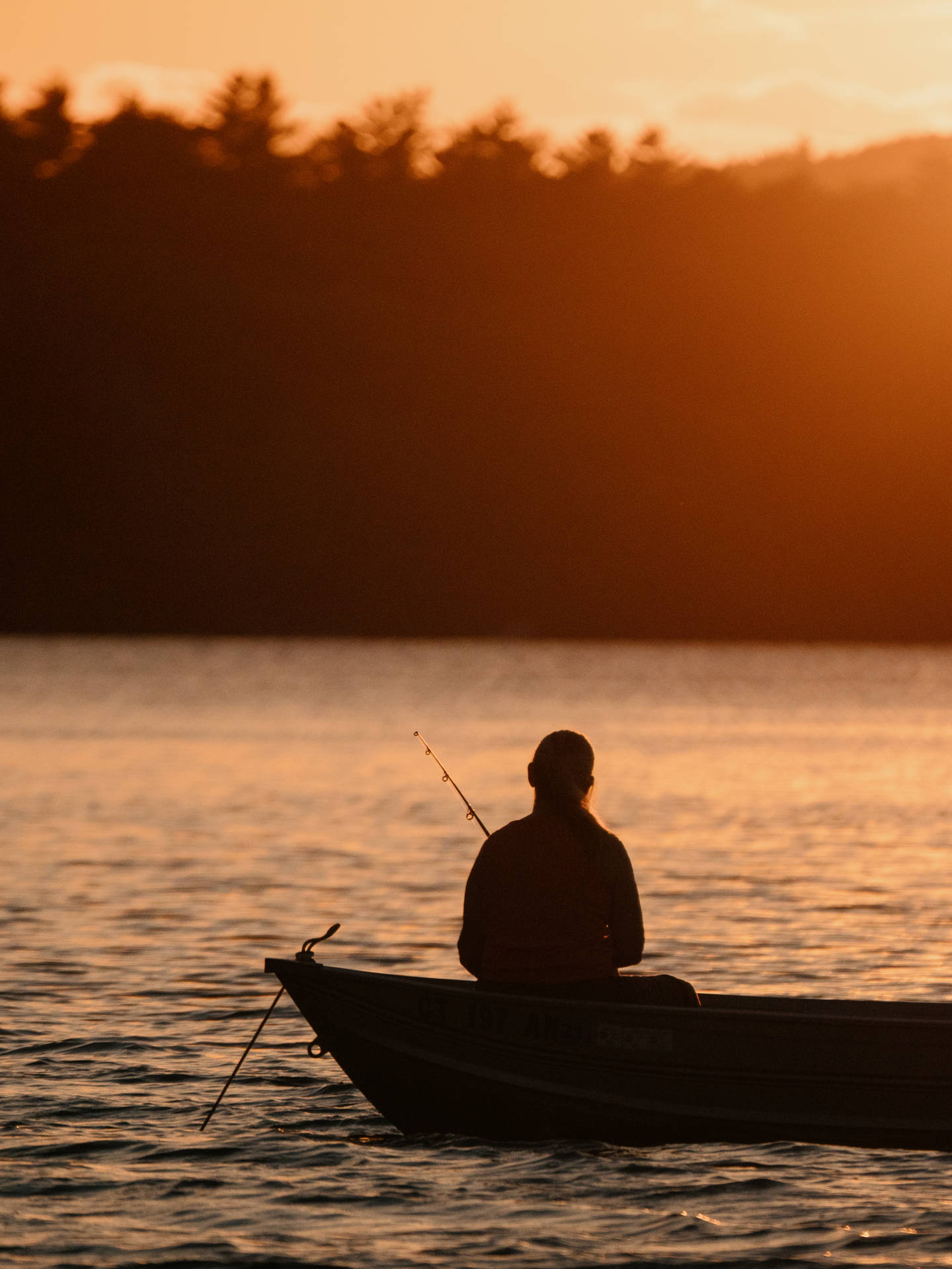 An Early Morning Angler Enjoying The Tranquility Of A Tranquil Fishing Boat. Background
