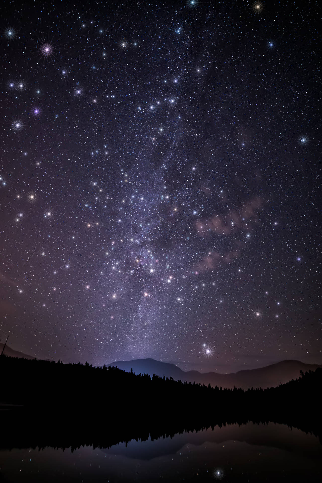 An Epic Night-time View Of A Mountain Landscape Surrounded By A Galaxy Of Stars. Background
