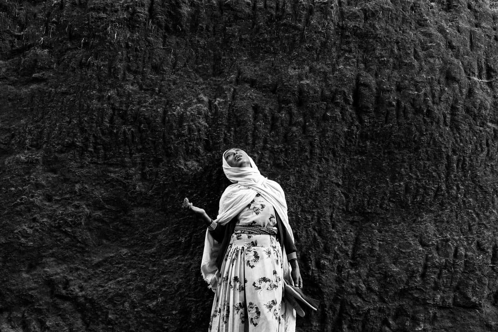 An Ethiopian Female Pilgrim In Lalibela Background