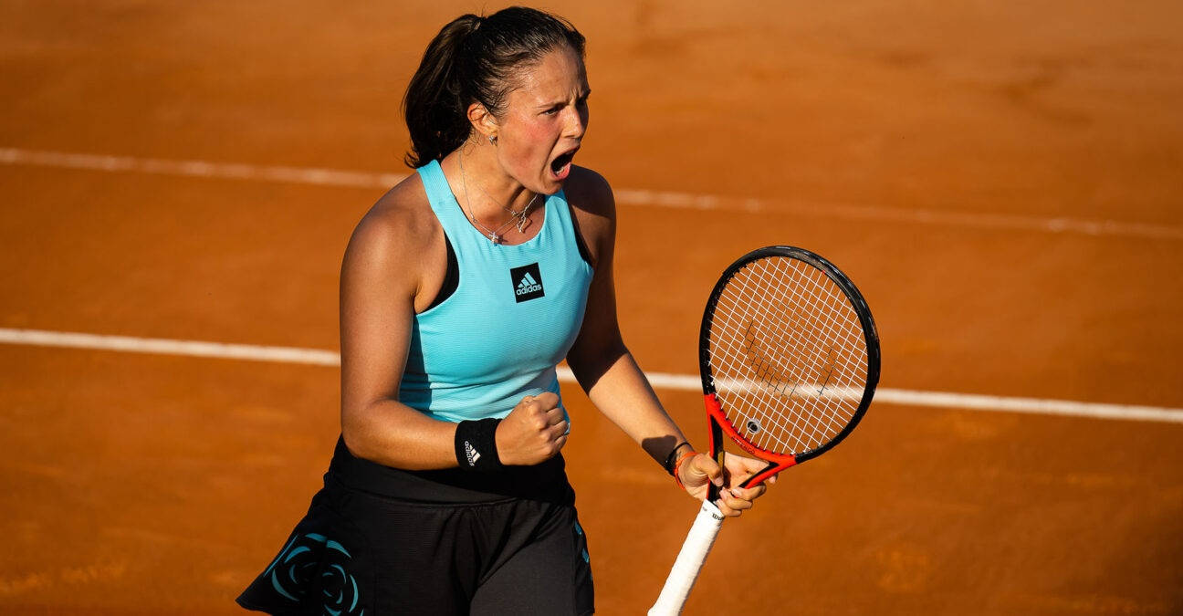 An Exhilarated Daria Kasatkina Celebrating Victory In Blue Background