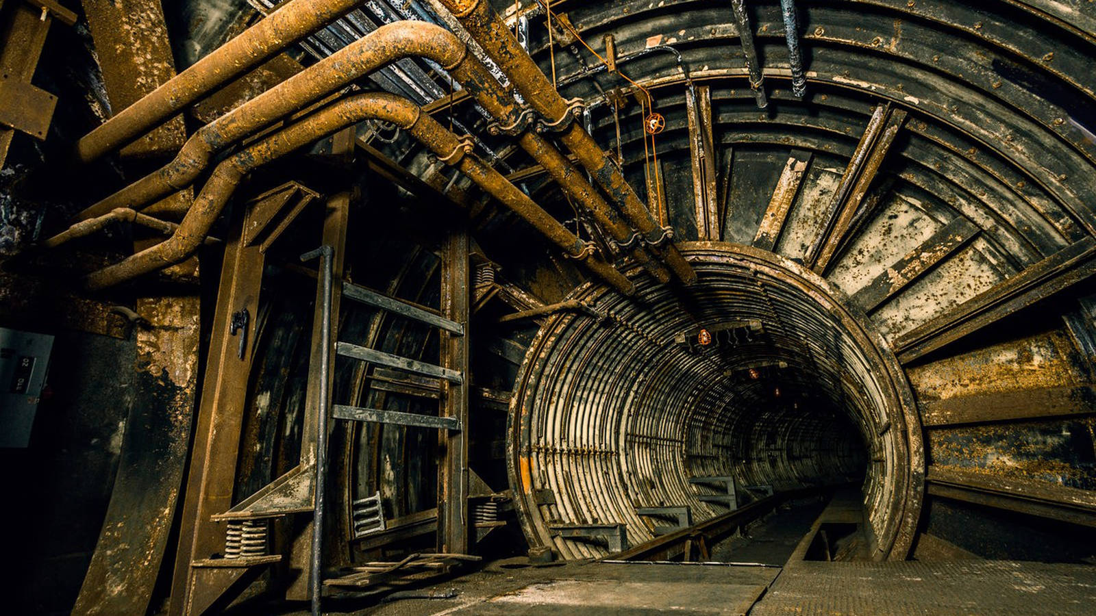 An Extensive Industrial Pipeline In Underground Tunnel Background