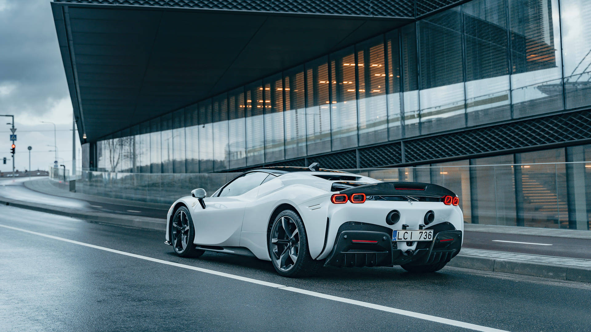 An Iconic Ferrari Spotted Driving Along The Street Background