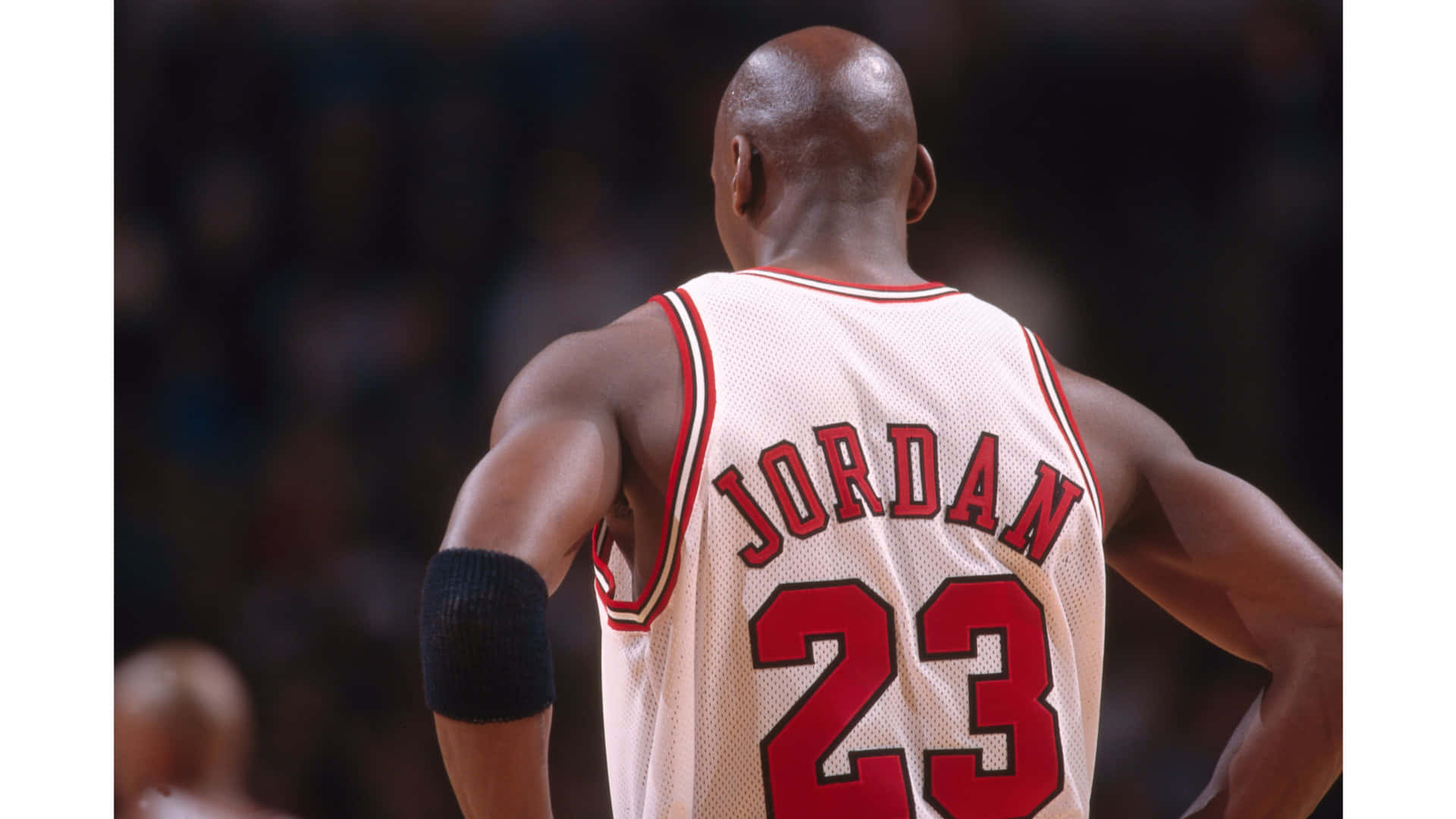 An Iconic Michael Jordan Jersey Hangs Off A Basketball Hoop, Creating A Powerful Connection Between The Goat And The Game Of Basketball. Background