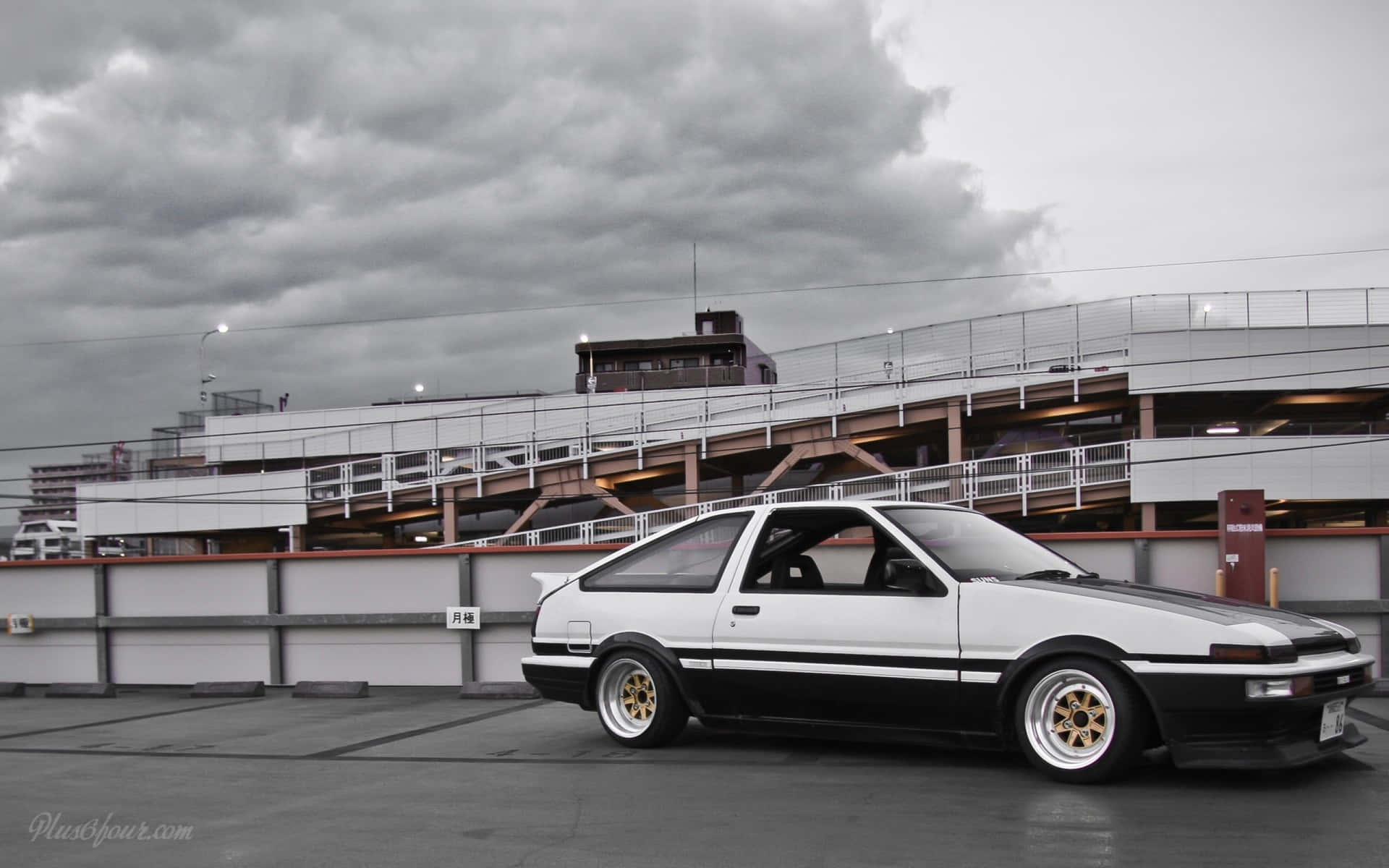 An Iconic Toyota Ae86 Framed Against A Beautiful Skyline Background