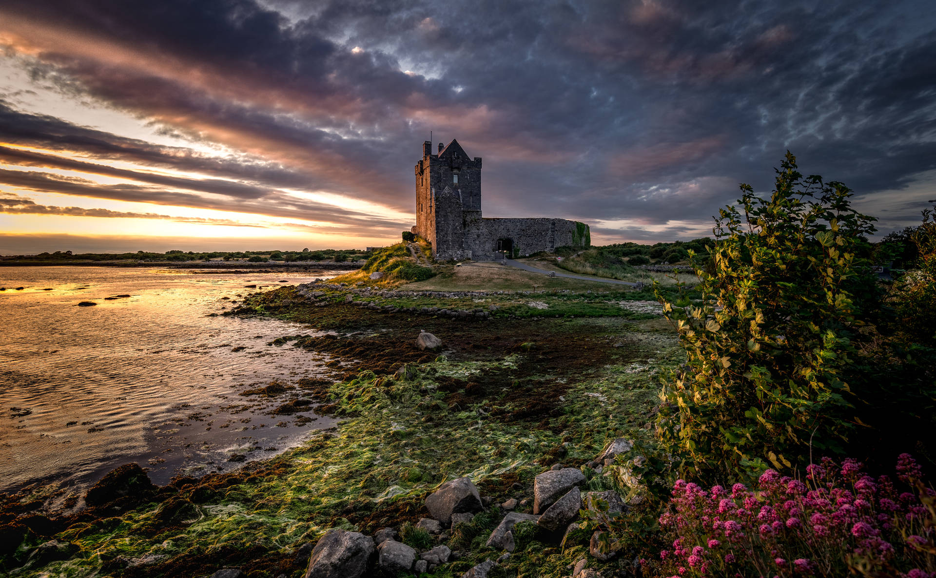 An Impressive Castle Overlooking The Coast Background