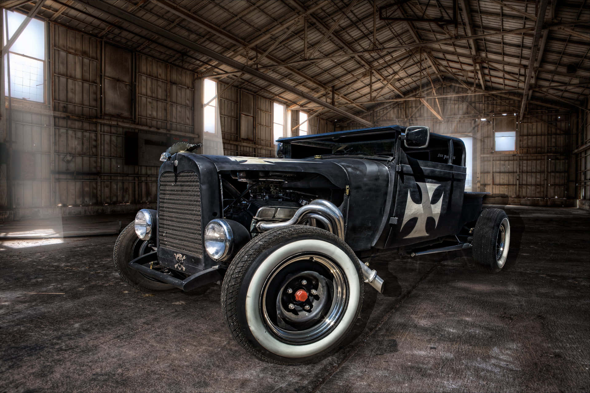 An Old Black Car In A Barn Background