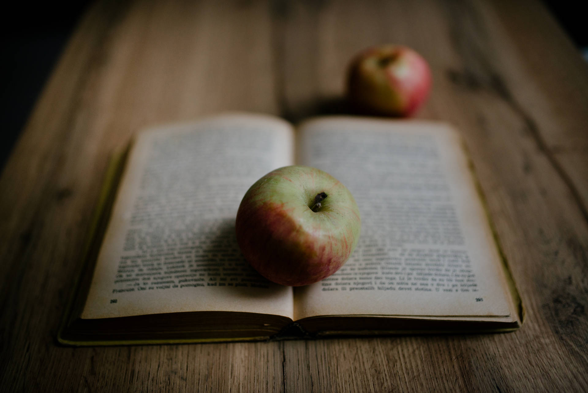 An Old Book And Apple Fruit Background