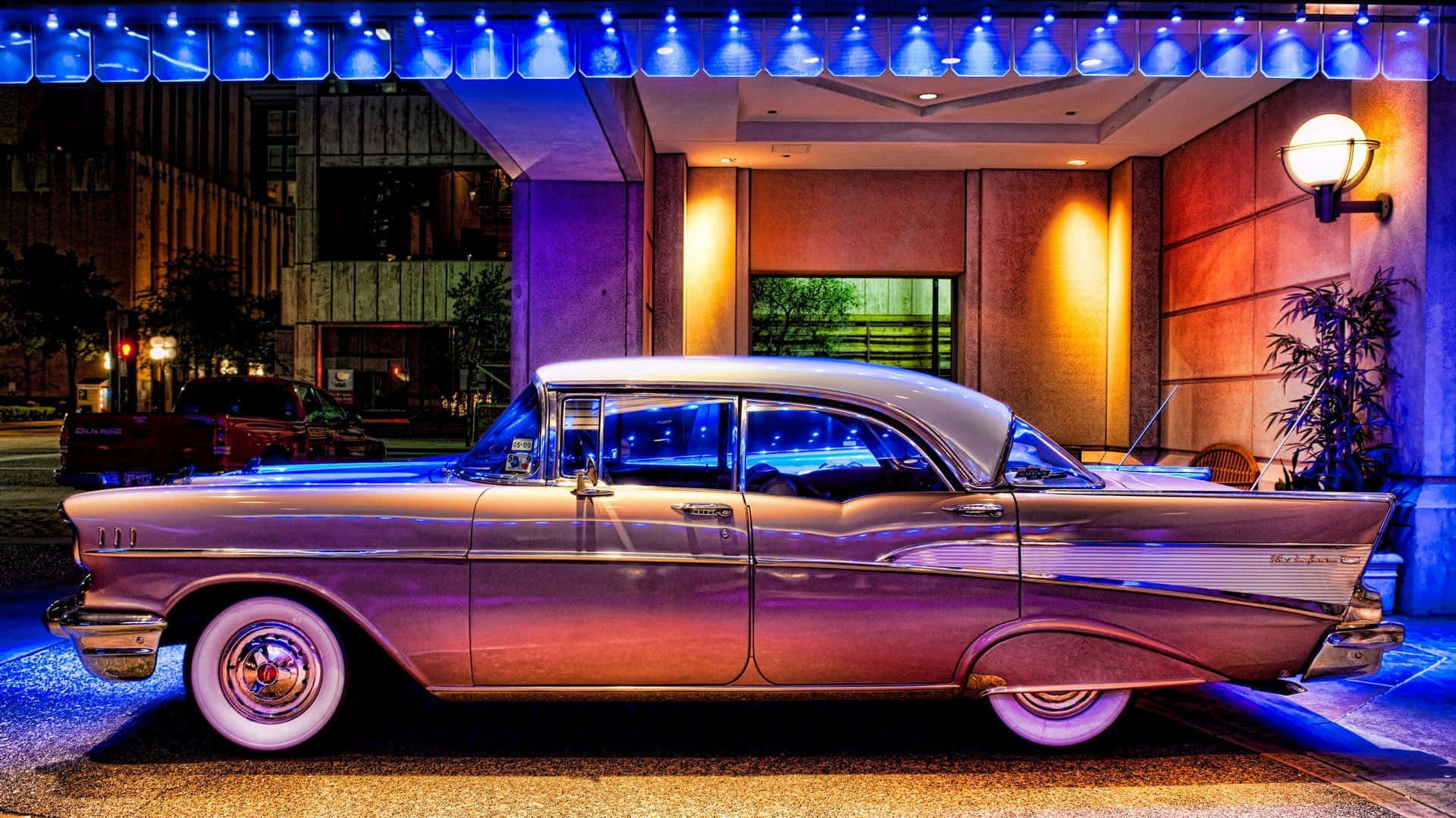 An Old Car Parked In Front Of A Building Background