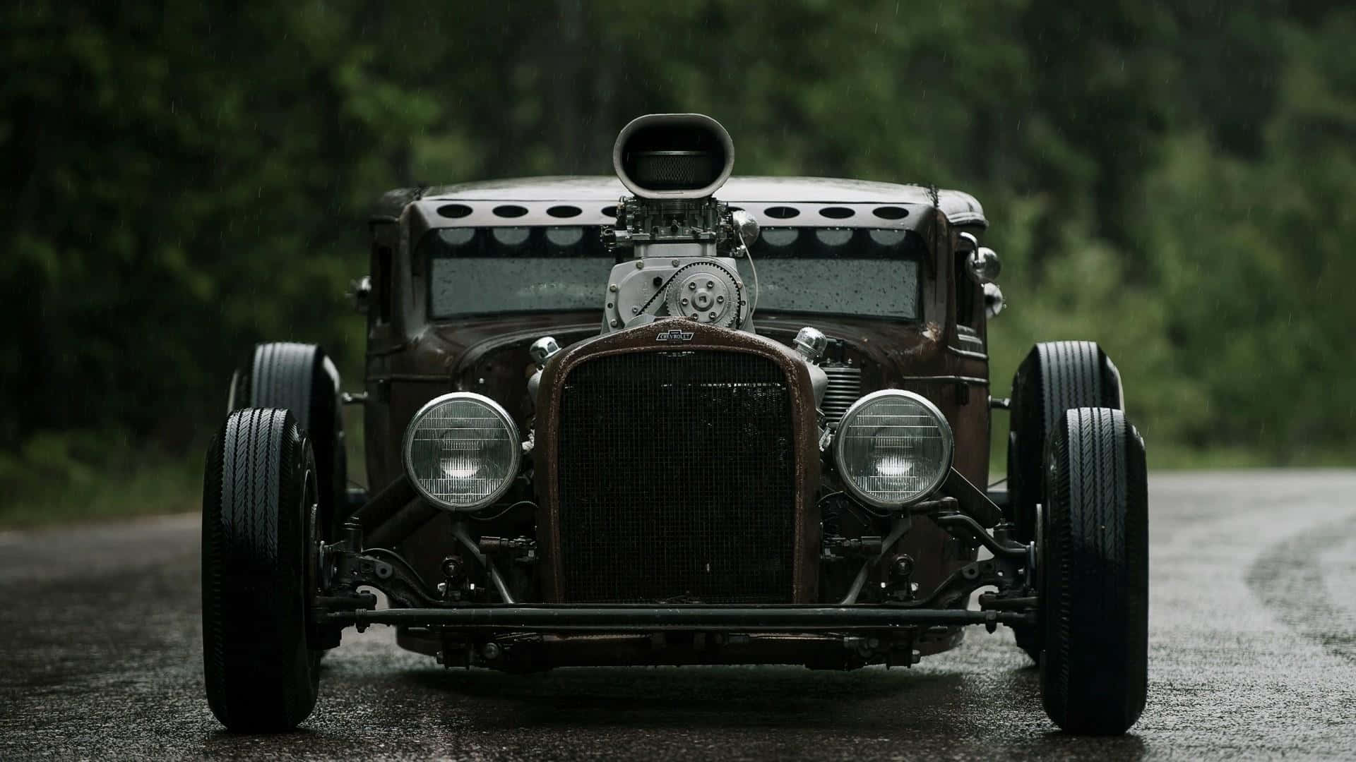 An Old Fashioned Car Driving Down A Road Background