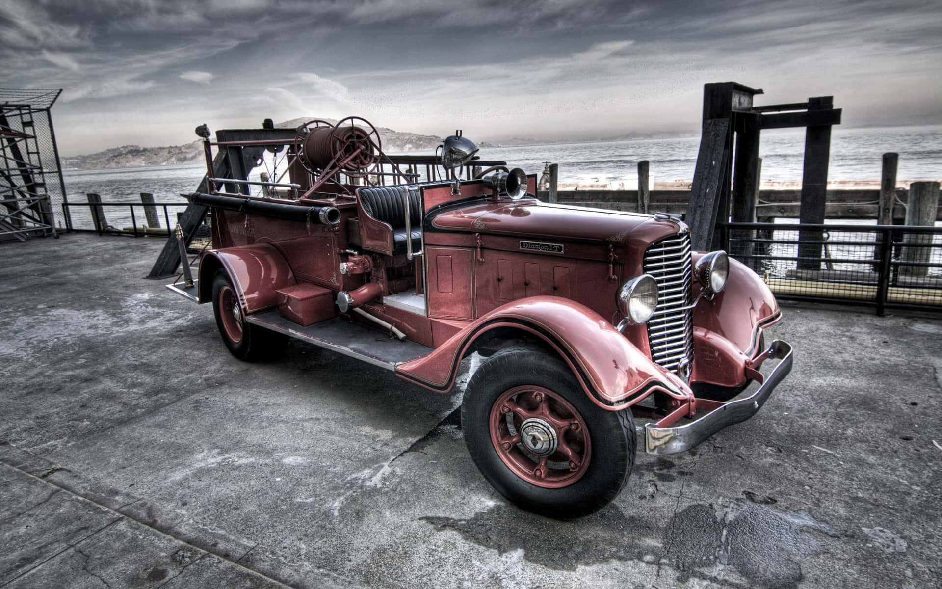 An Old Fire Truck Parked On A Dock Background