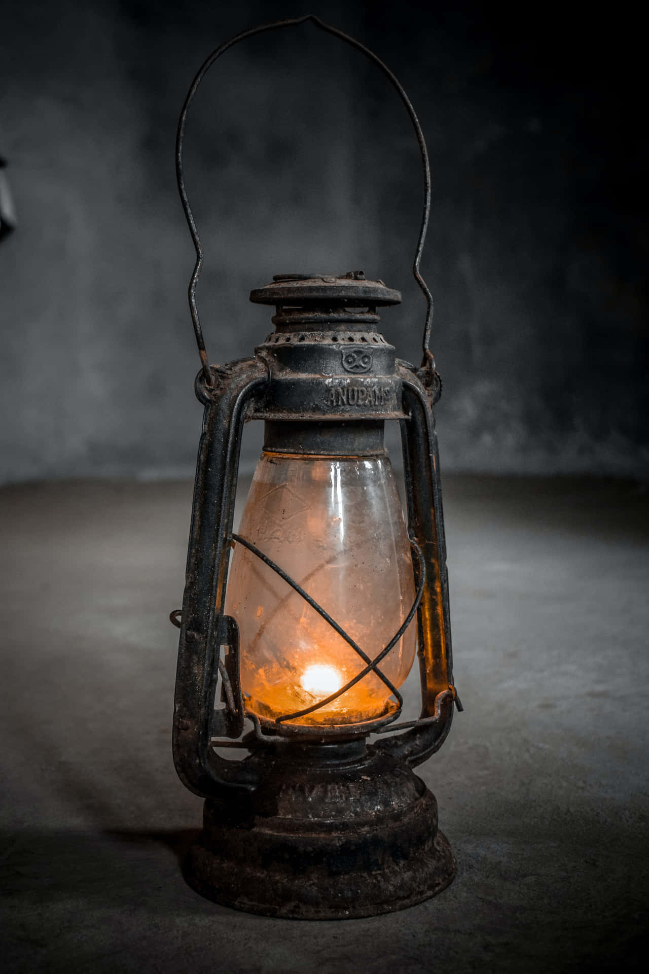 An Old Lantern Is Lit In A Dark Room