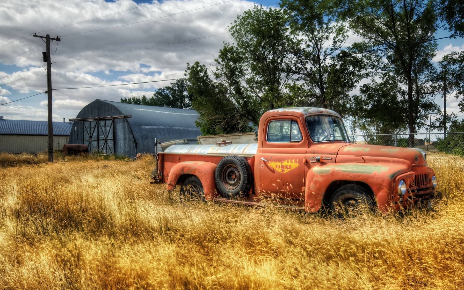 An Old Truck In A Field Background