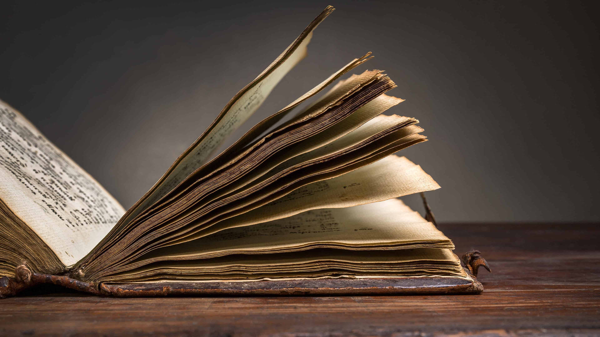 An Open Book On A Wooden Table Background