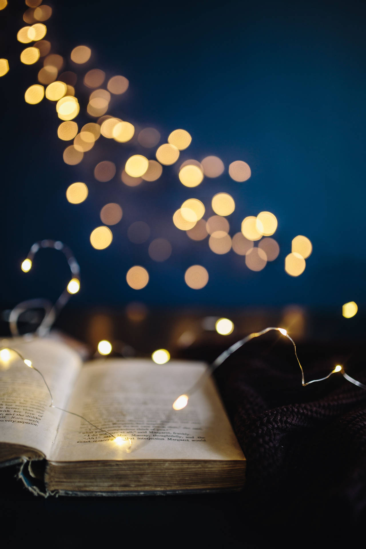 An Open Book With Lights On It Background