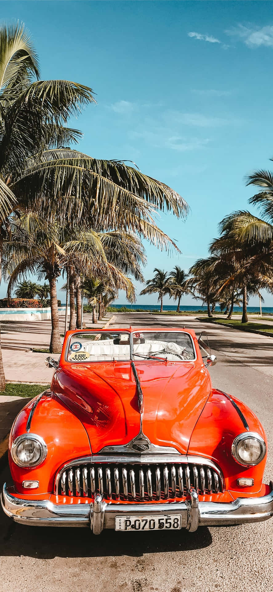 An Orange Classic Car Parked On The Beach Background