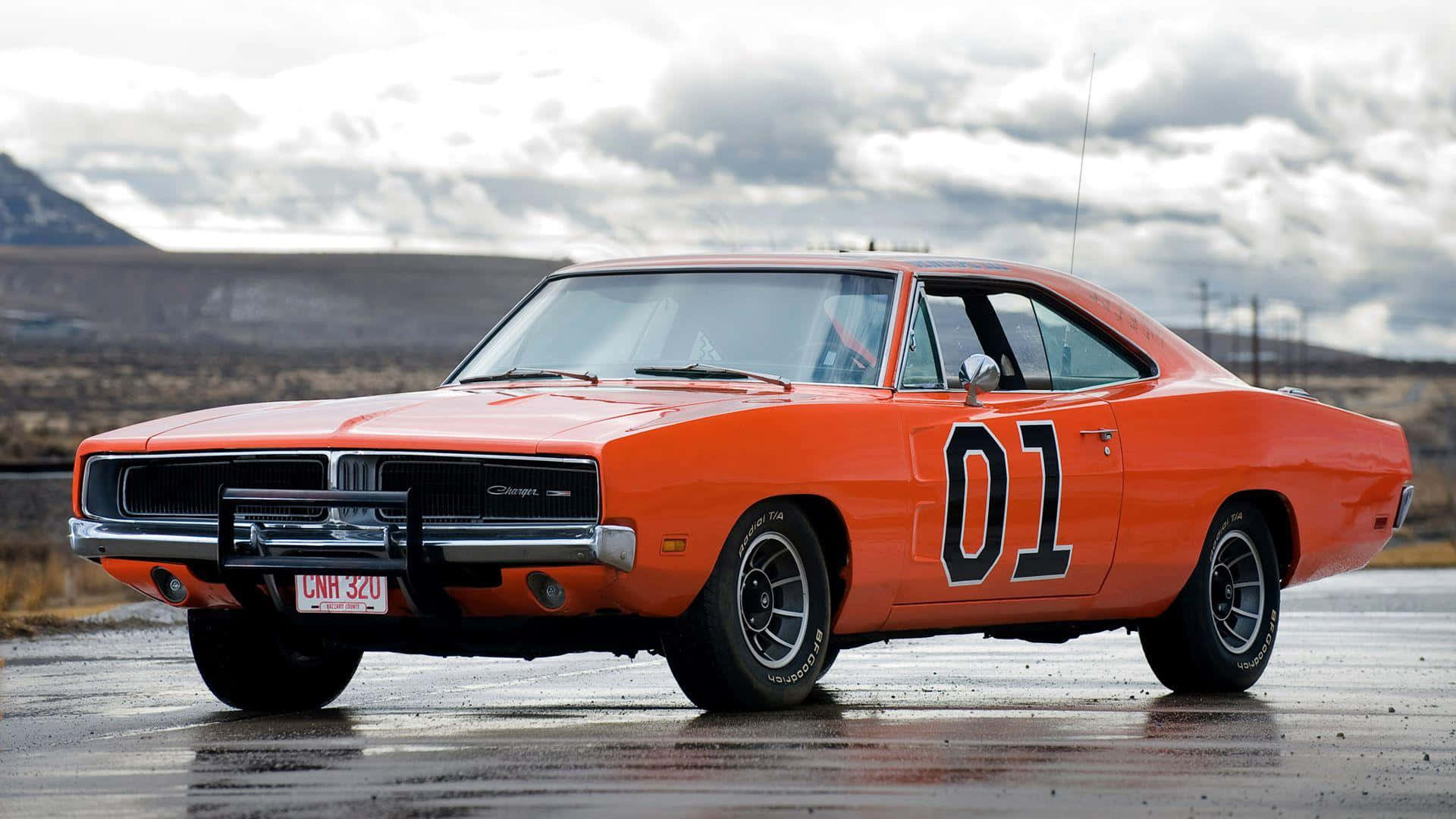 An Orange Dodge Charger Is Parked On The Road Background