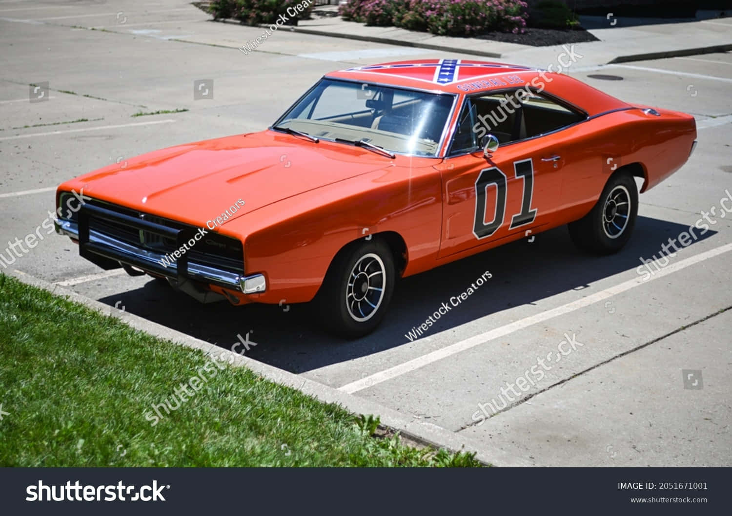 An Orange Dodge Charger Parked In A Parking Lot