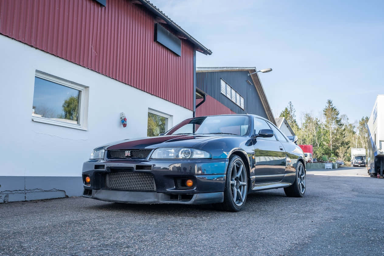 An R33 Gtr Performance Supercar Speeding Ahead Background