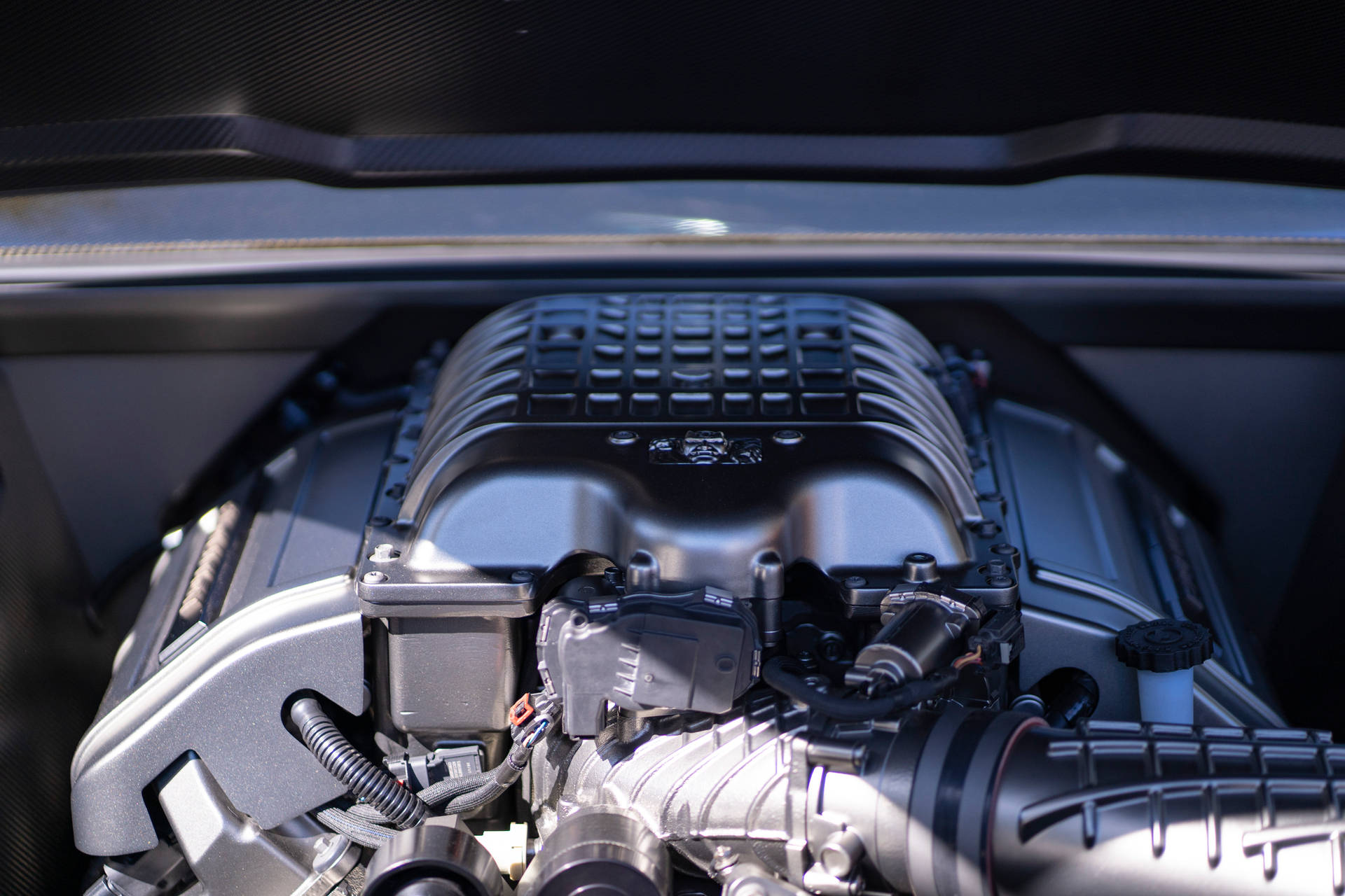 An Up-close Look At A Black And Silver Car Engine