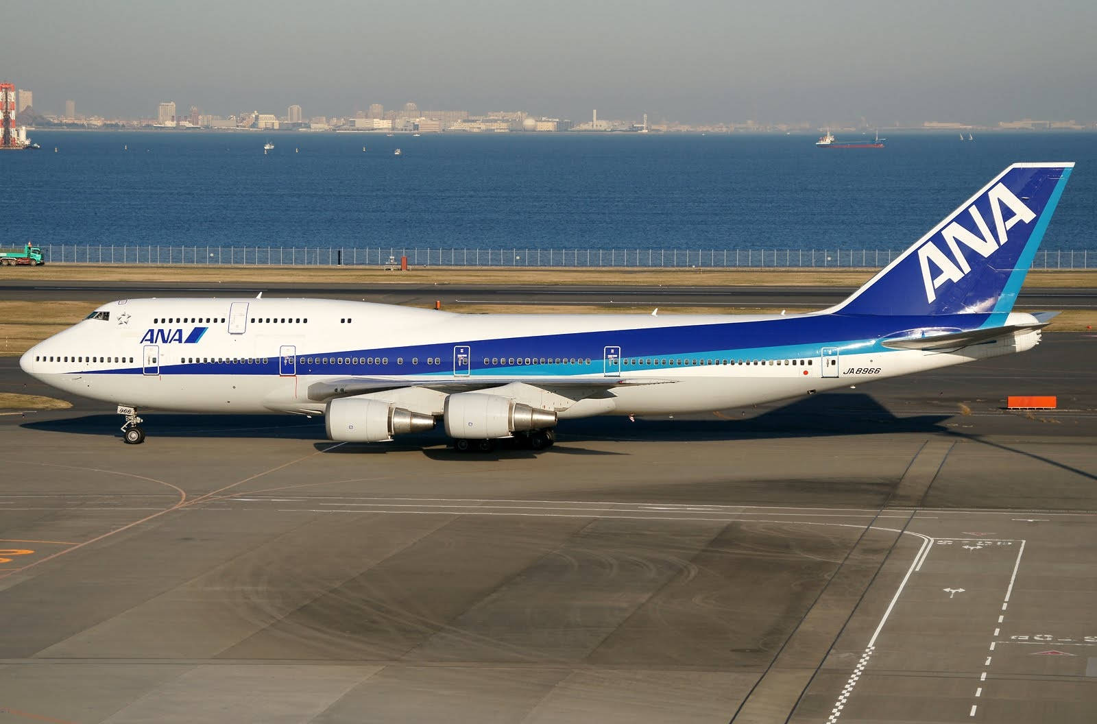 Ana Airplane Near A Blue Sea Background