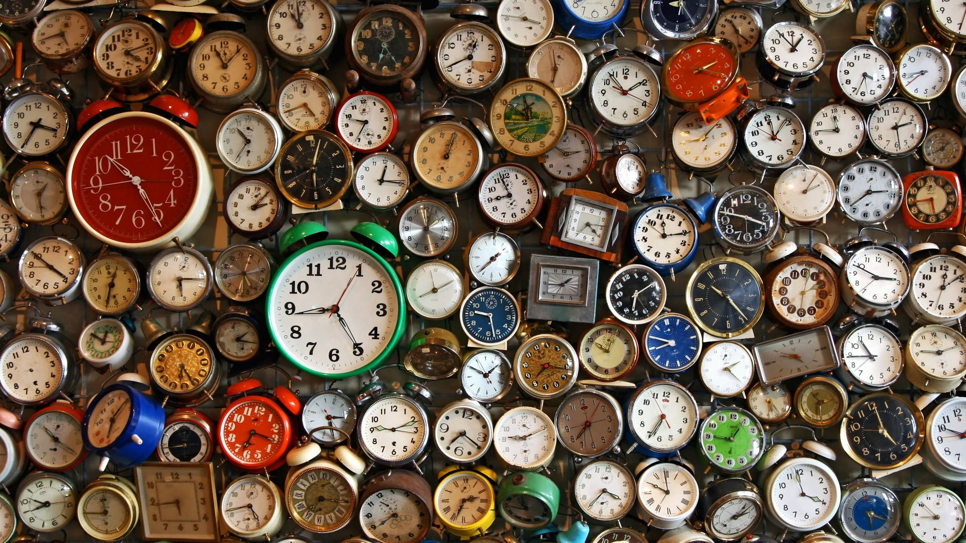 Analog Alarm Clock On A Table Background