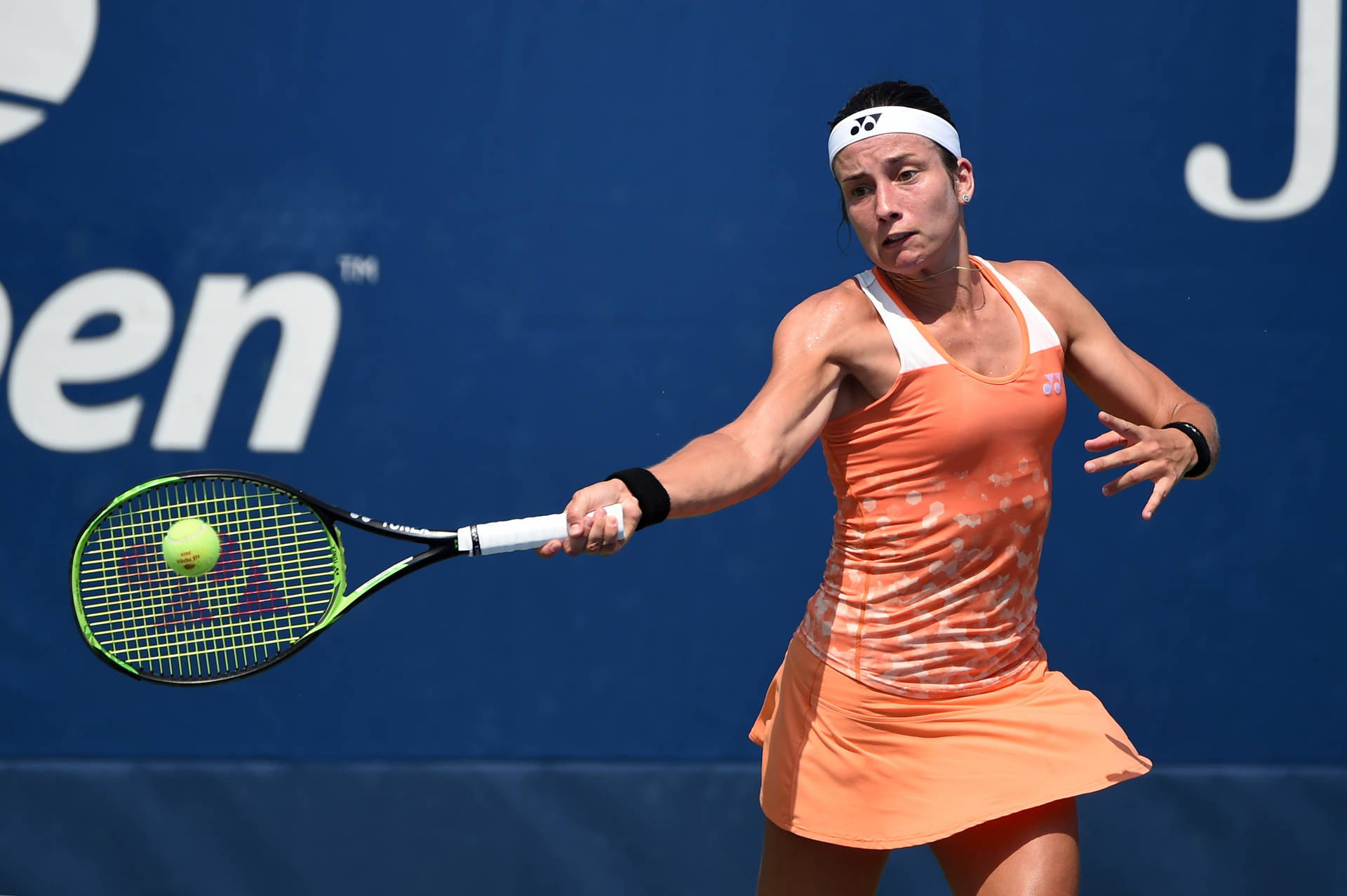 Anastasija Sevastova Dominating The Court In Peach Tennis Dress Background