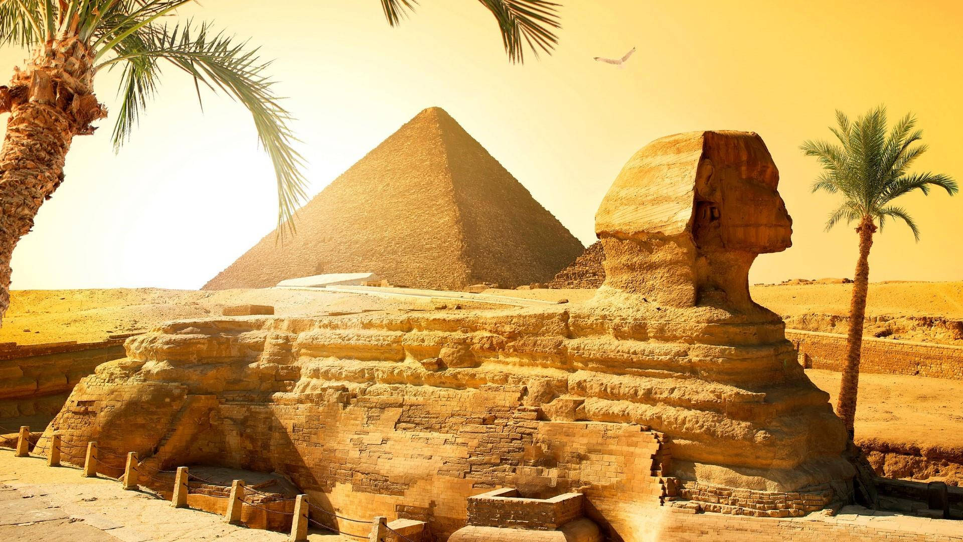 Ancient Wonders At Greater Cairo - The Iconic Pyramids Of Giza And The Sphinx Background