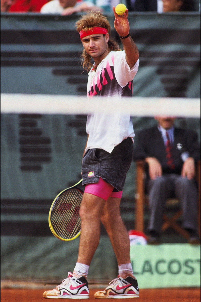 Andre Agassi Holding A Tennis Ball Background