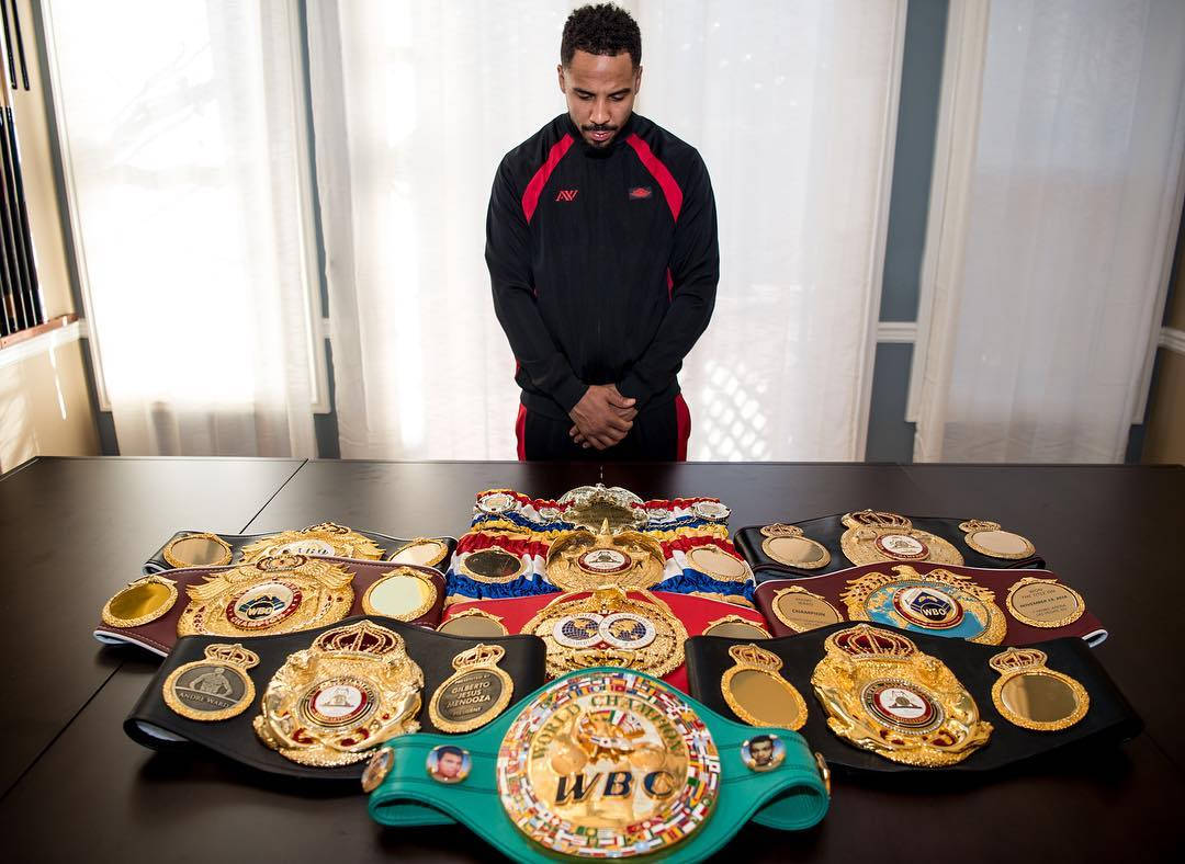 Andre Ward Looking At His Title Belts Background