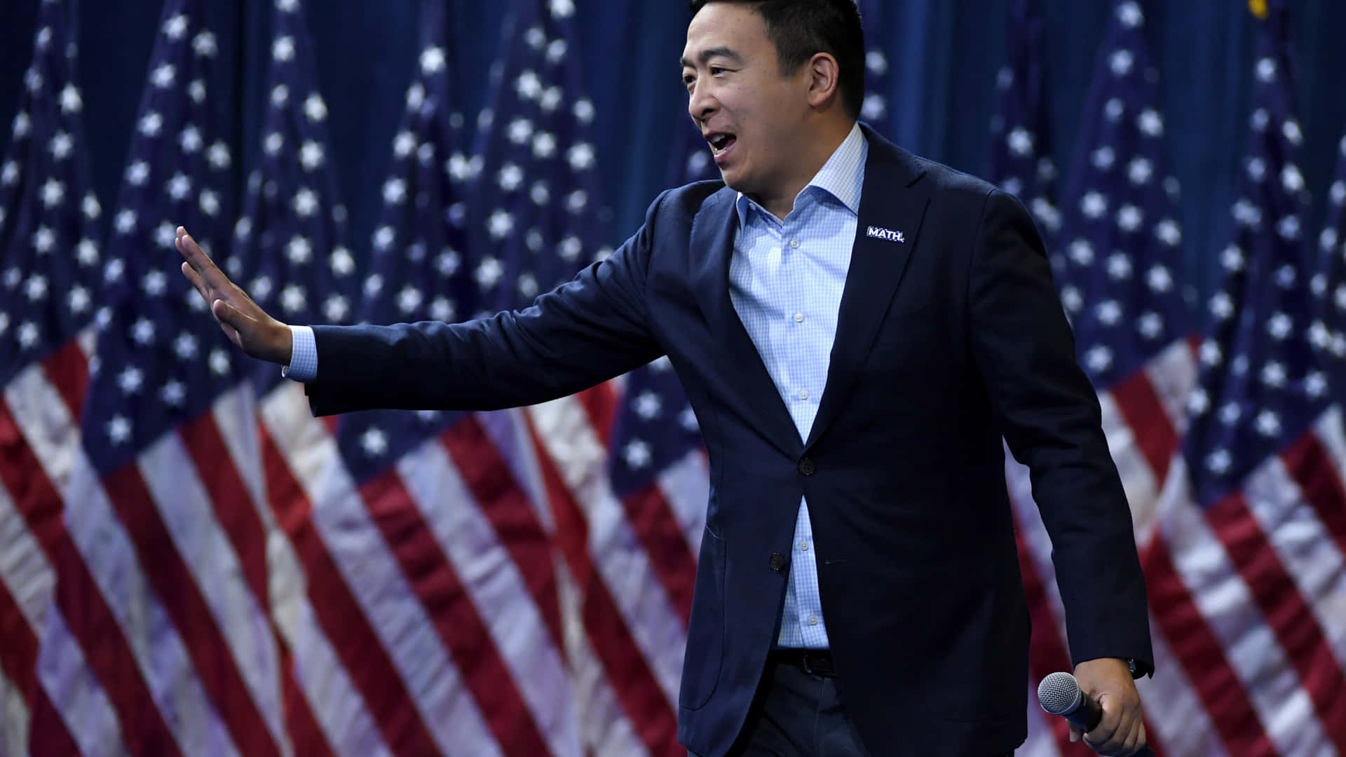 Andrew Yang Waving With American Flags Background