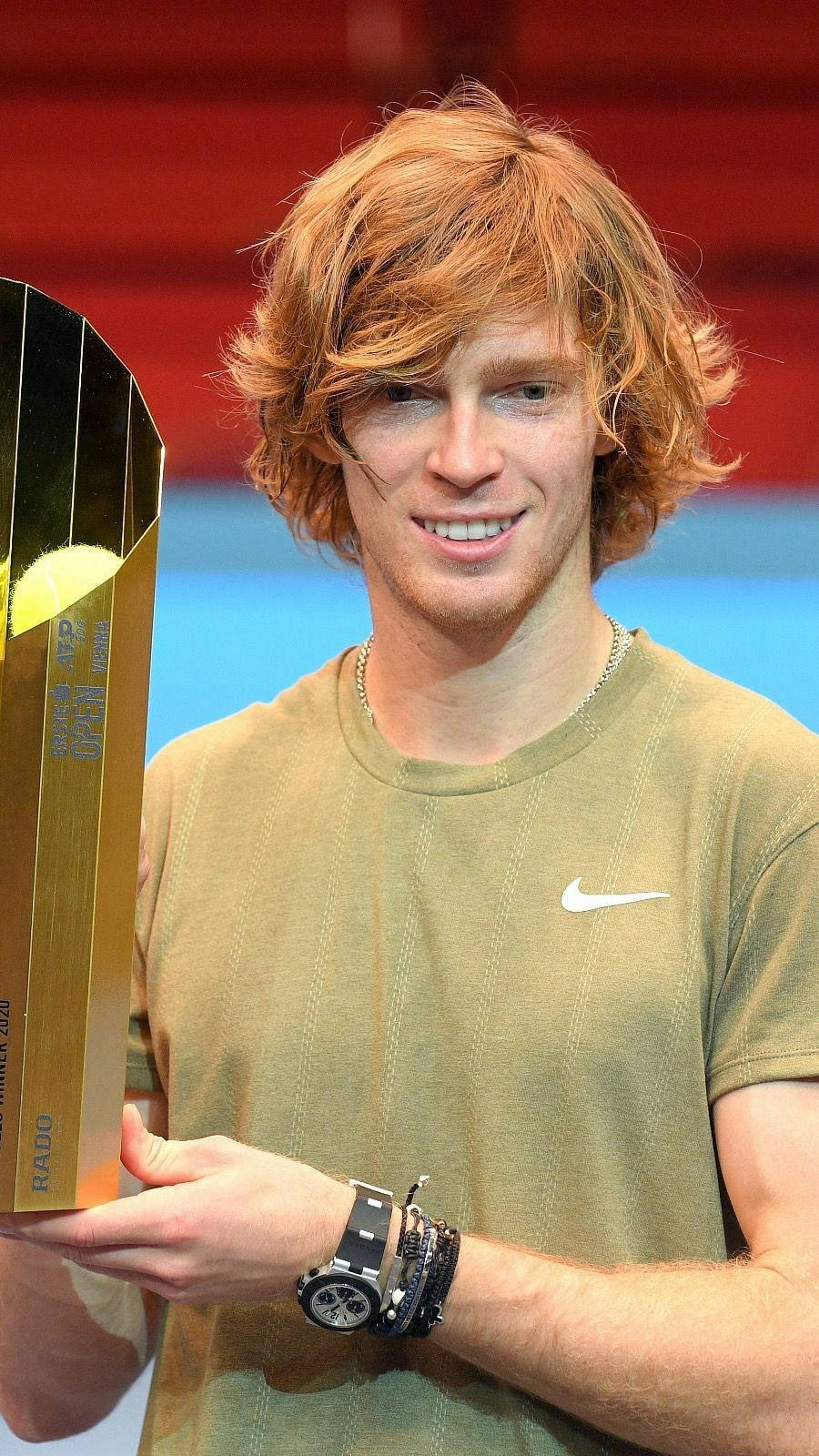 Andrey Rublev Holding A Gold Trophy Background