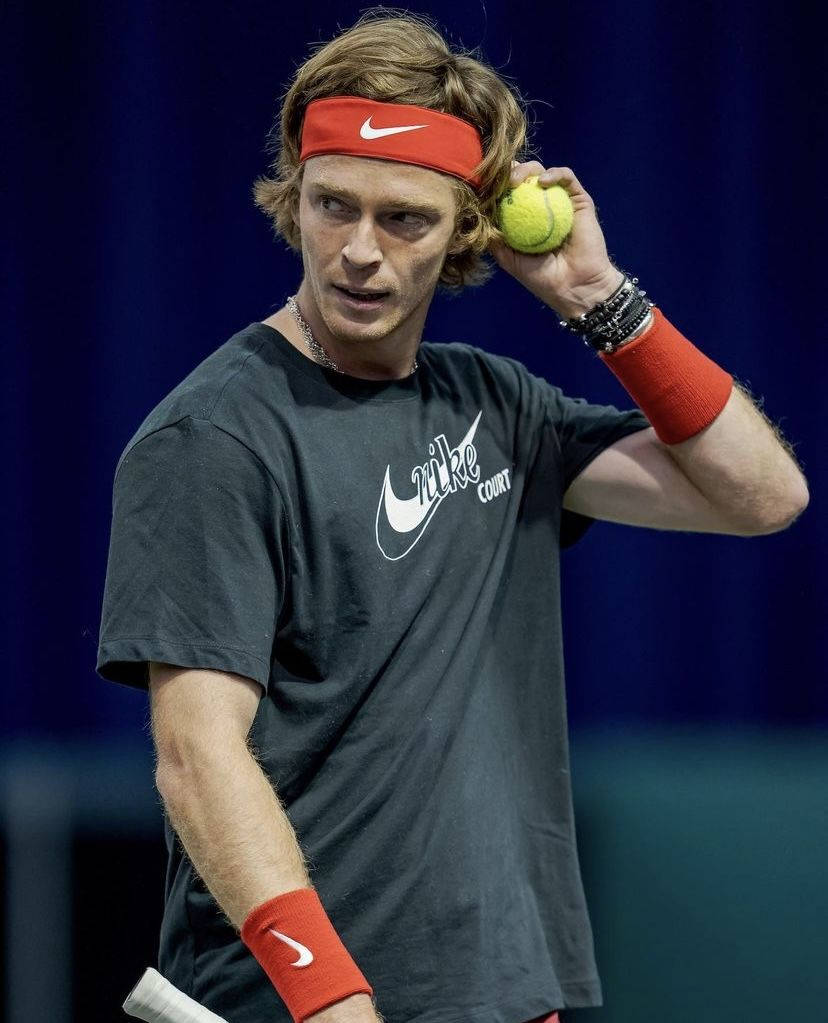 Andrey Rublev Holding A Tennis Ball Background