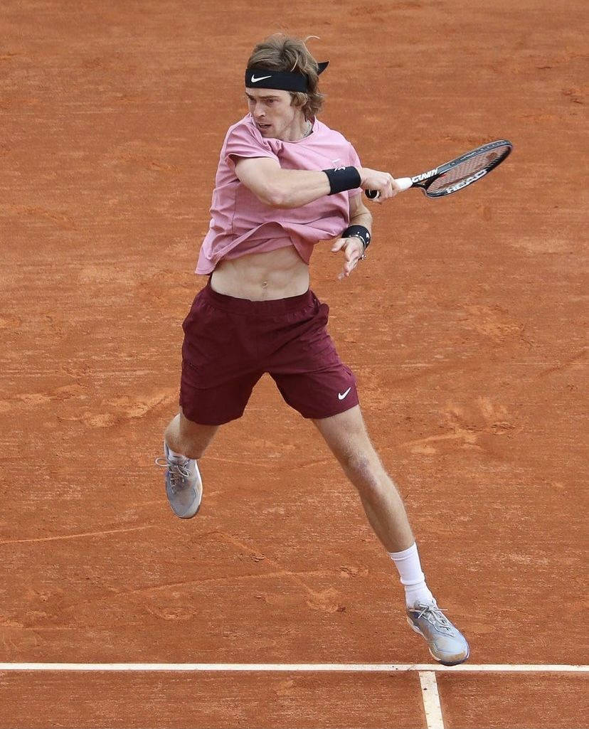 Andrey Rublev In Action During A Tennis Match Background