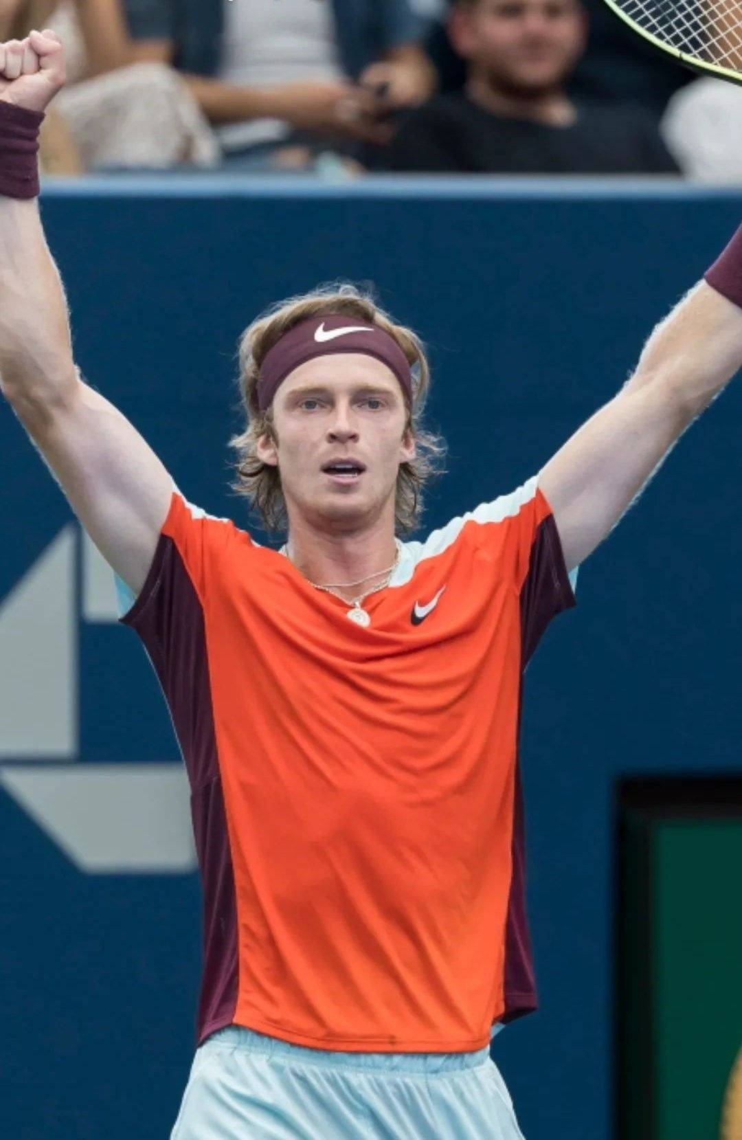 Andrey Rublev In Orange Tennis Shirt Background