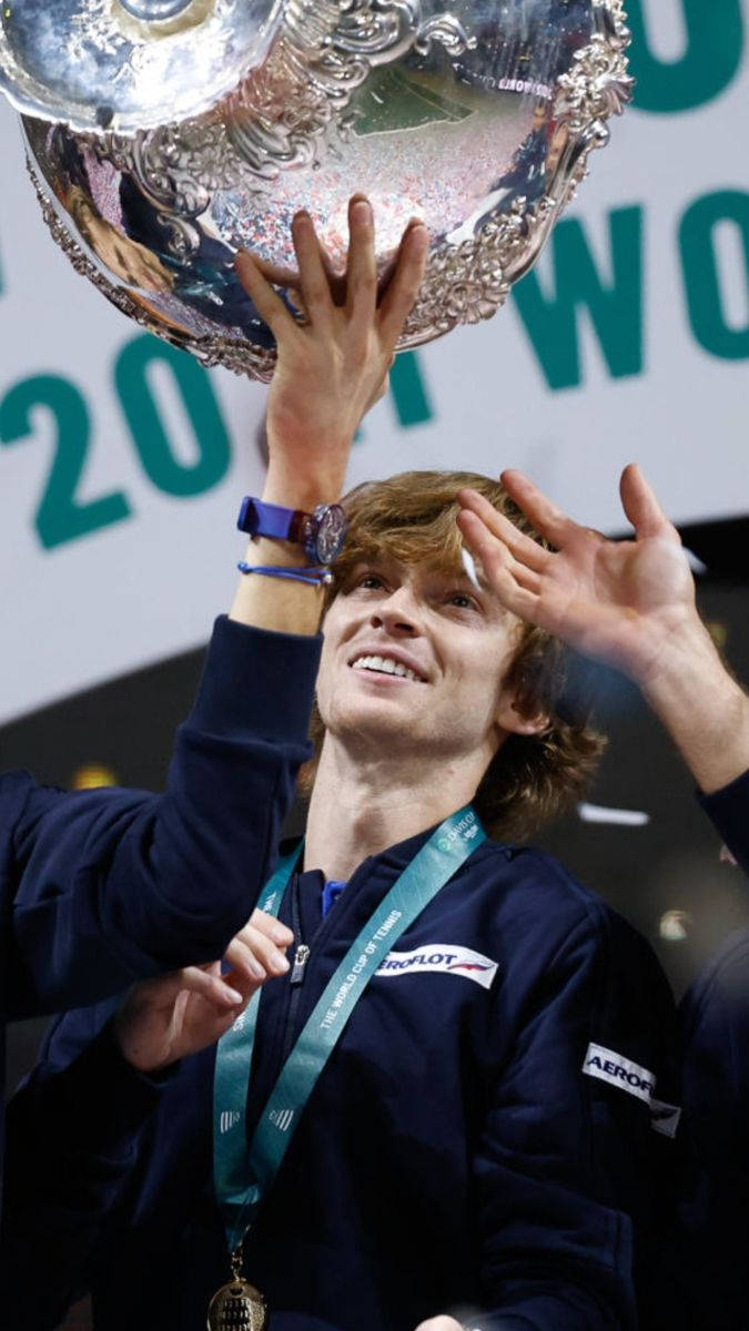 Andrey Rublev Looking At A Trophy Background